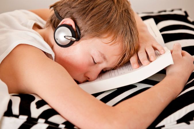 Boy-listening-to-music-while-sleeping