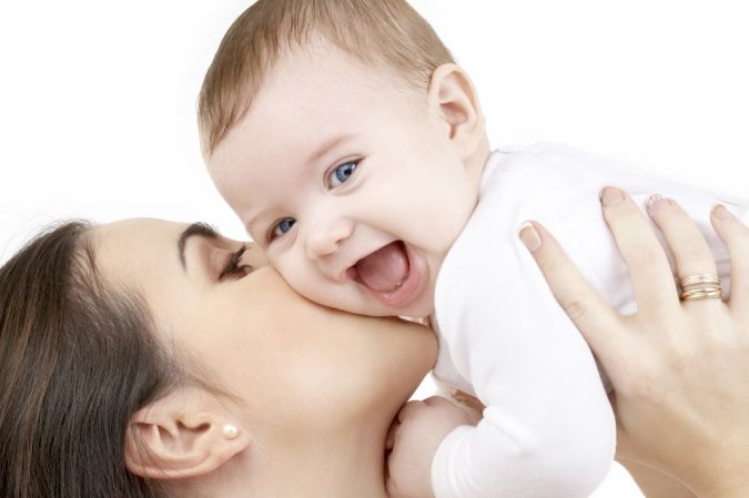 laughing baby playing with mother