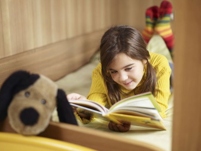 girl reading in bed
