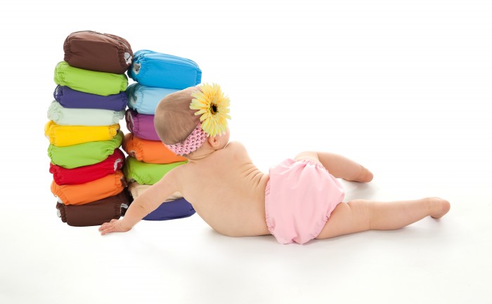 baby-girl-with-stack-of-diapers