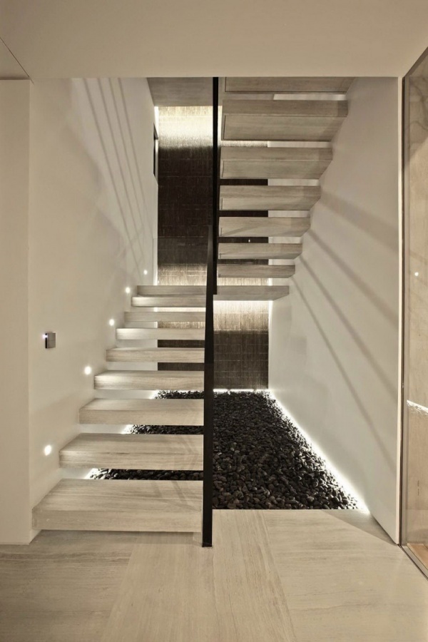 White-Wooden-Stairs-With-Black-Fences-Placed-With-Stone-Under-It Turn Your Old Staircase into a Decorative Piece
