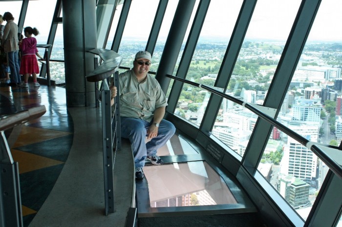Sky Tower that is located in Auckland, New Zealand. It features a glass window in the floor which allows you to see the buildings under your feet. 