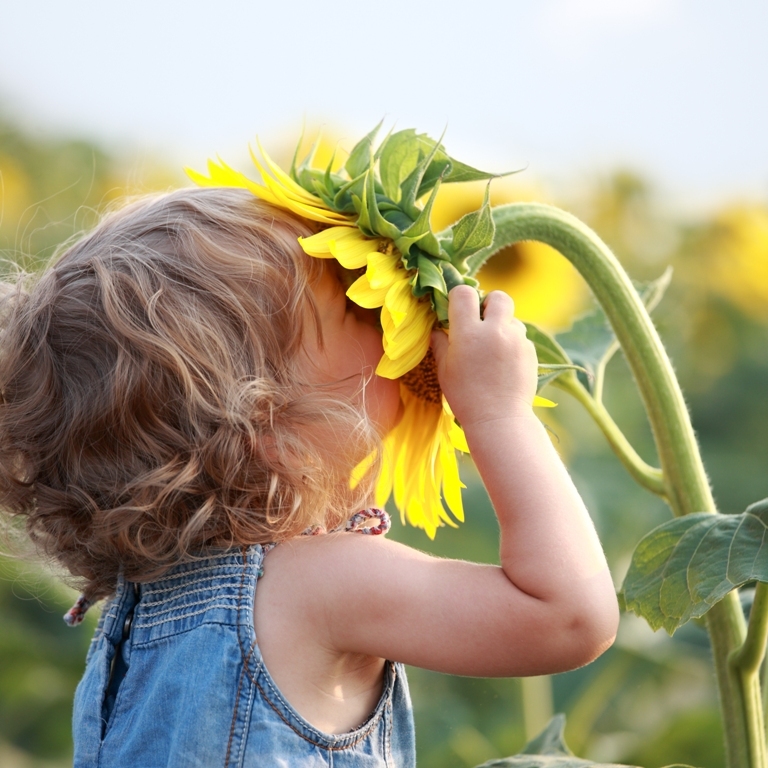 child-smelling-flower