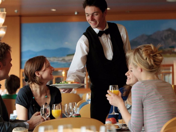 15 Tips to Help You Save Money on Entertainment 31 family-eating-in-the-restaurant_-waiter-serving-food-to-the-table_base1