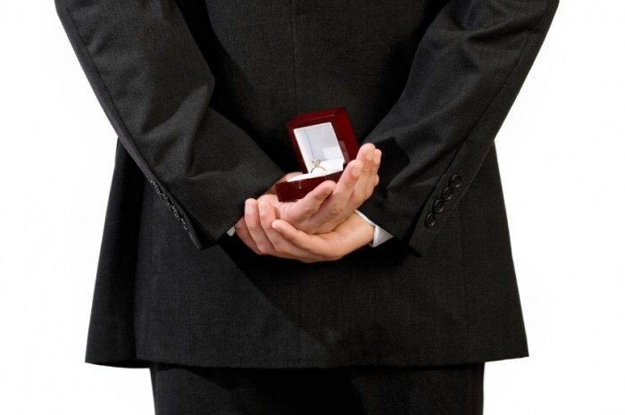 man-holding-engagement-ring