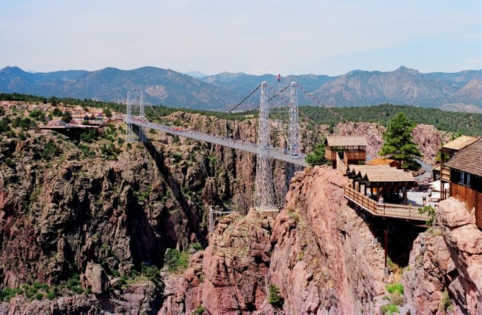 Royal Gorge Bridge It is located in Colorado and crosses over the Arkansas River. It is considered to be the highest suspension bridge in America as it is 969 feet high above gorge. 