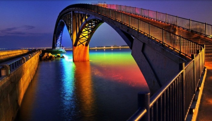 Xiying Rainbow Bridge It can be found in Penghu, Taiwan. This bridge is traditional like other bridges during the day, but at night it turns to another bridge with its lights that take the color of rainbow. 