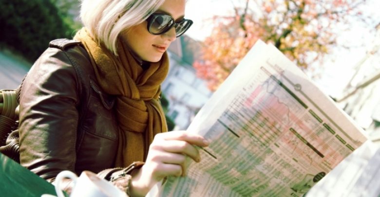 girl with newspaper Top 10 Trends in the Newspaper Industry - newspapers 1