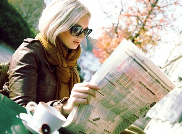 girl-with-newspaper Top 10 Trends in the Newspaper Industry