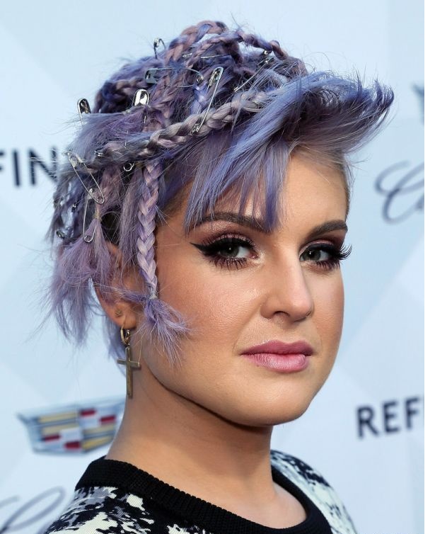 Kelly Osbourne with several short braids, shaved sides and pins but do not know for what. It is definitely the worst hairstyle that you can ever choose.
