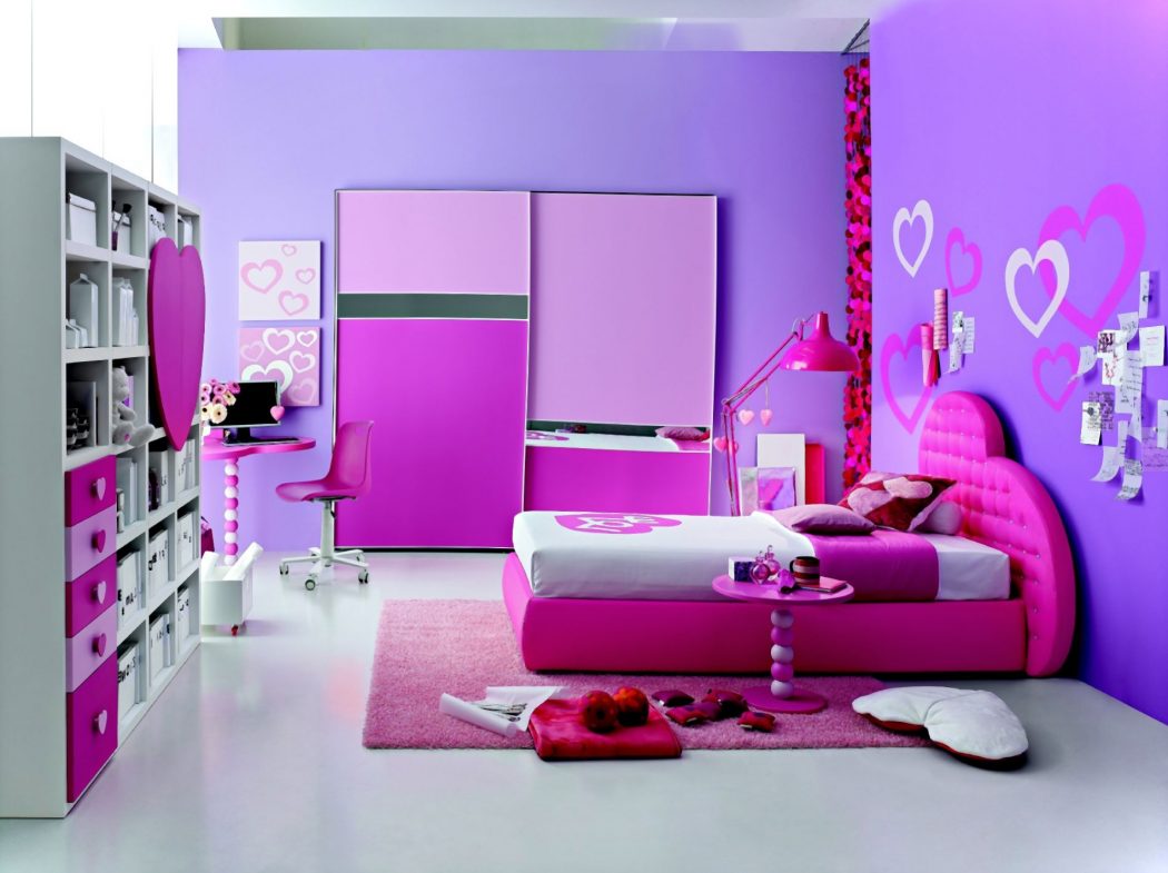 a luggage rack on the left and a computer desk top computer is also adjacent to the left corner and then the mattress is also the floor with a pink carpet and wall with pink paint also 5 Main Bedroom Design Ideas - 4