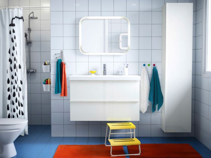 astounding-kids-bathroom-decorating-ideas-with-beautiful-plastic-shower-curtains-and-orange-rectangle-bath-mat-on-blue-floor-tiles-as-well-as-floating-washing-stand-under-mi-675x504 5 Bathroom Designs of kids' Dreams