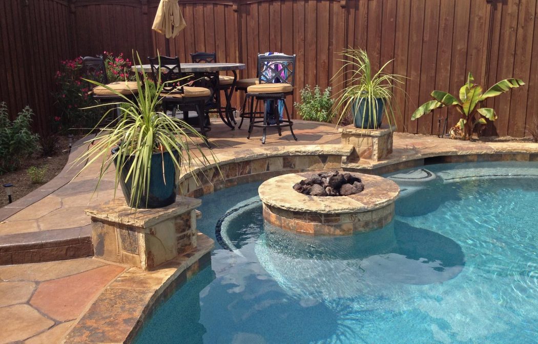 Fire-Pit-inside-Pool-with-Bench-in-Frisco 8 Delightful and Affordable Fire pit Decoration Designs in 2022