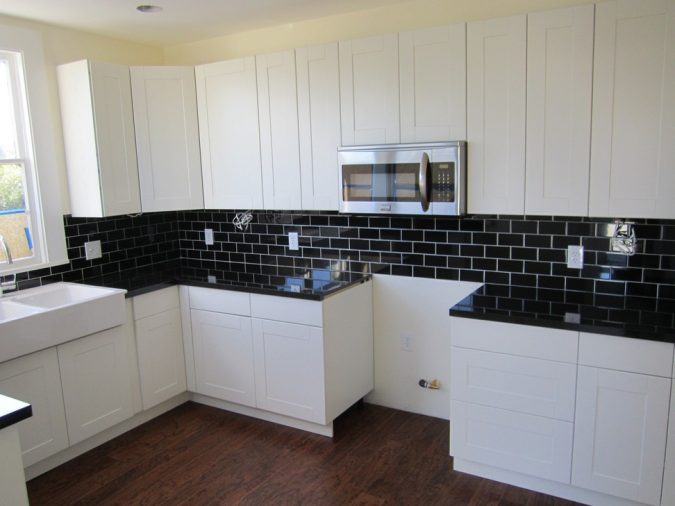 white kitchen with dark surfaces 3 Top 10 Best White Bright Kitchen Design Ideas - 10