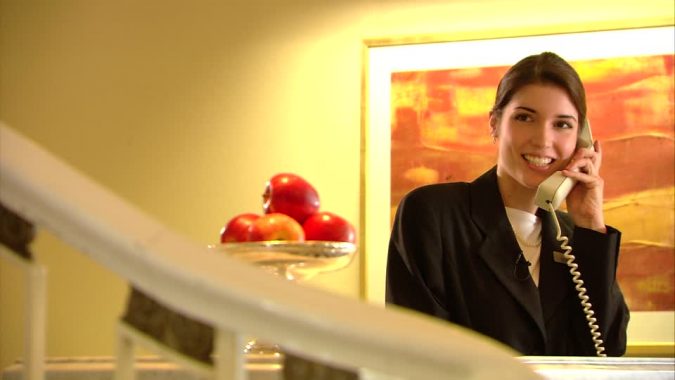 Top 10 Exclusive Tips to Find Cheapest Hotel Deals 20 hotel receptionist calling check in Top 10 Exclusive Tips to Find Cheapest Hotel Deals - 20