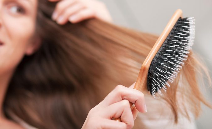 Top 10 Best Hair Masks for Color Treated Hair 8 woman brushing her hair 2 Top 10 Best Hair Masks for Color Treated Hair - 8
