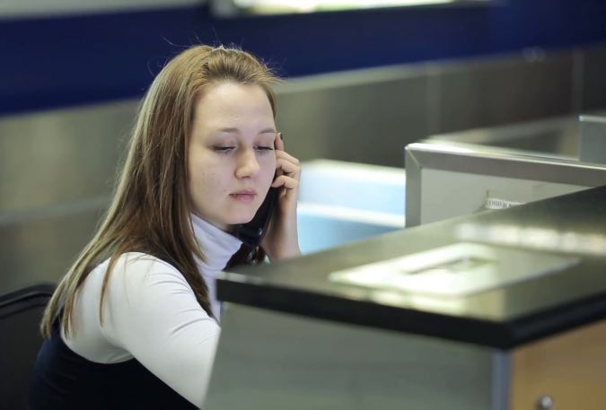 woman in airport reception area calling phone 1 Top 10 Exclusive Tips to Find Cheapest Hotel Deals - 16