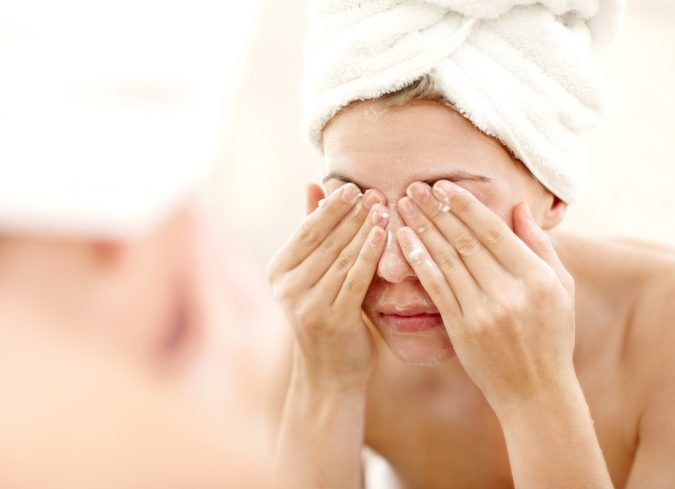 woman washing face 9 Face Mapping Acne Spots and What Every Acne Spot Means? - 18