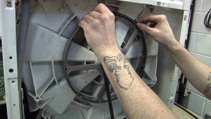 Top 10 Washing Machine Parts That Need Repair in Canada 9 replacing washing machine Water Pump Belt Top 10 Washing Machine Parts That Need Repair in Canada - 9