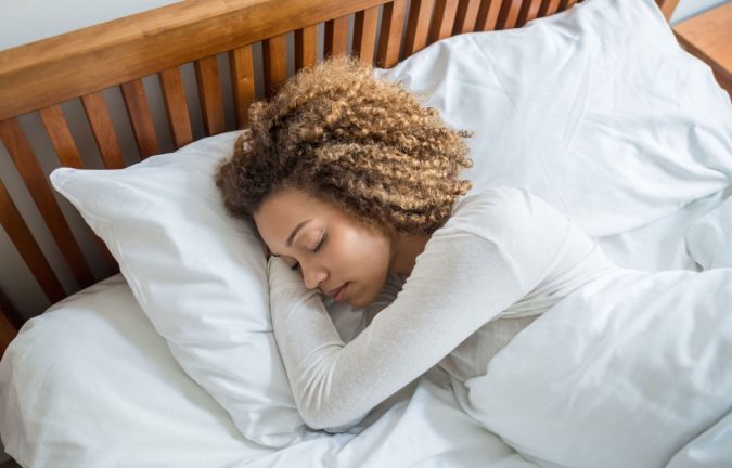 sleeping woman bed 6 Ways to Stay Healthy on a Busy Schedule - 4