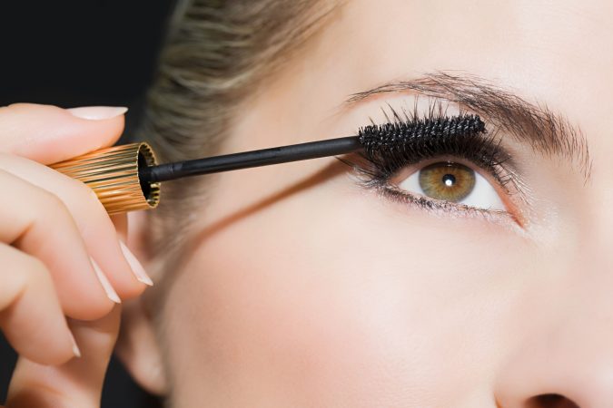 Top 10 Tricks to Remove Makeup Stains from Clothes Easily 11 woman applying mascara Top 10 Tricks to Remove Makeup Stains from Clothes Easily - 11