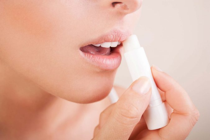 7 Tricks to Keep Your Lipstick Last Longer 3 woman moisturize lip balm 7 Tricks to Keep Your Lipstick Last Longer - 3