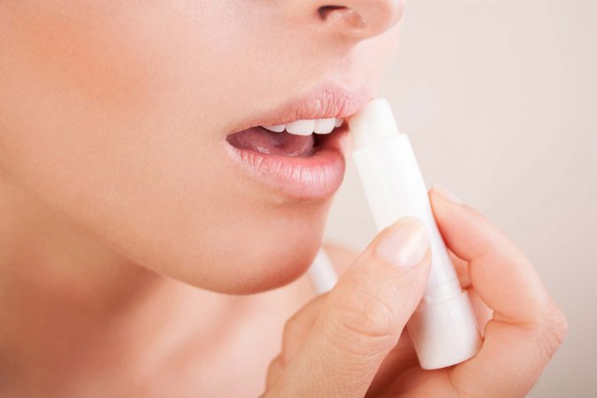 woman moisturize lip balm 7 Tricks to Keep Your Lipstick Last Longer - 3