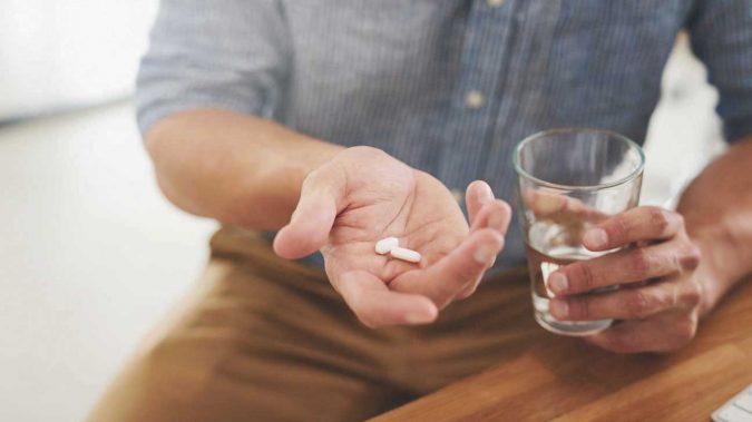 man holding pills and glass water Creatine Dr. Mark Schwartz’s Harmony Place Offers Best Treatment of Bipolar Disorder - 10