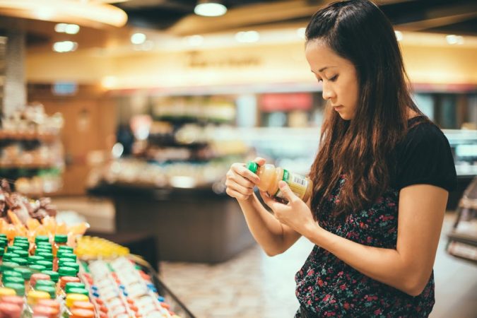 shopping woman reading nutrition label Getty 10 Things to Consider Before Buying Food for Your Family - 18