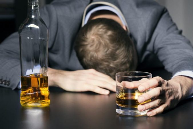 drinking alcohol Drunk businessman holding a glass of whiskey 0 Holistic Ways to Fight Stress and Find Peace - 7