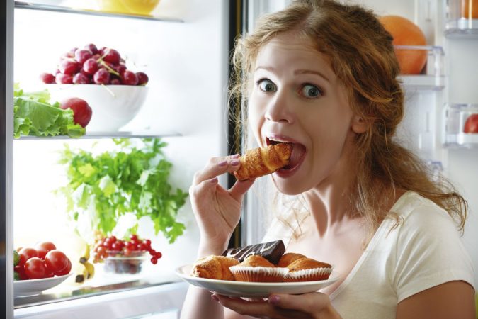 stress overeating woman late night snacking refridgerator eating food iStock 000069204943 Medium Holistic Ways to Fight Stress and Find Peace - 8