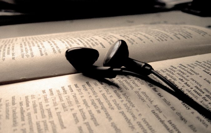 Top 10 Ways to Relax if You Are a College Freshman 15 book headphones listening to tutorial while studying Top 10 Ways to Relax if You Are a College Freshman - 15