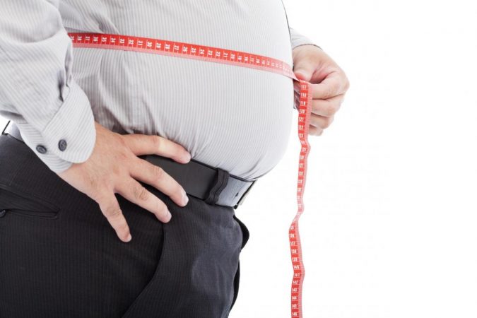 Spotlight on the Paleo Diet: Is It for You? 2 obesity a man measuring his waist Spotlight on the Paleo Diet: Is It for You? - 2