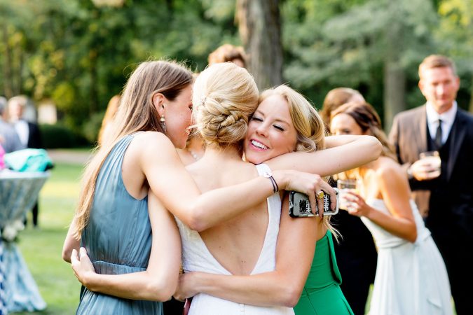 bride hugging friends after wedding 10+ Outdated Wedding Trends That Brides Should Avoid - 19
