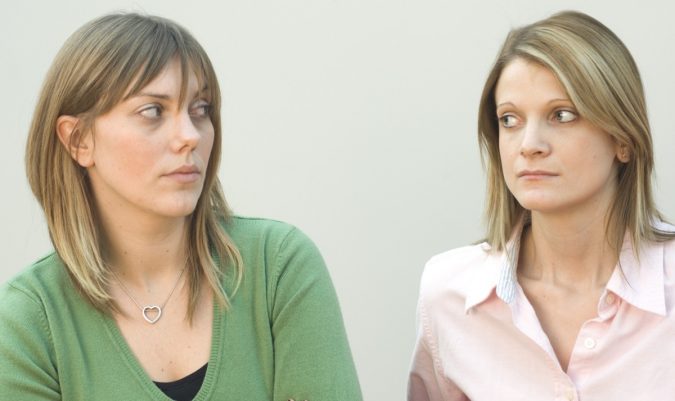 woman looking at each other jealousy What Expats Should Know Before Returning Home - 4