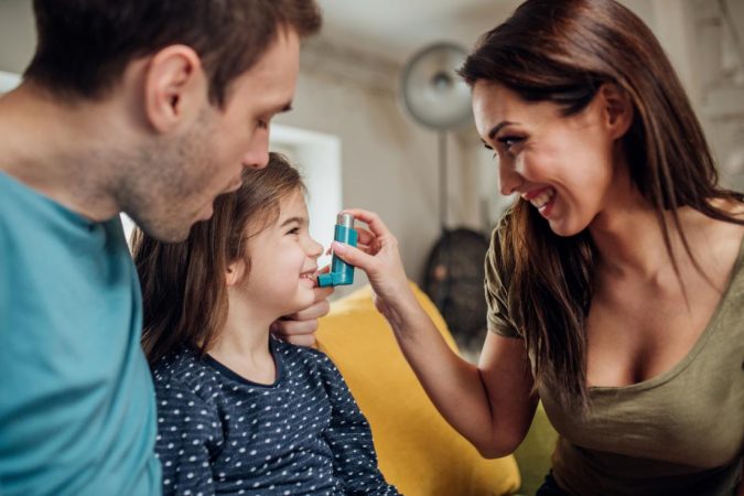 parents helping young daughter to use inhaler Rare Genetic Disorder: 5 Ways to Show a Family Emotional Support - 7