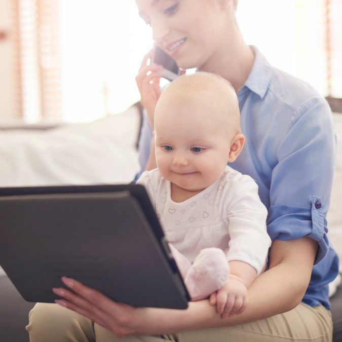 tablet woman working and holding child Rare Genetic Disorder: 5 Ways to Show a Family Emotional Support - 6