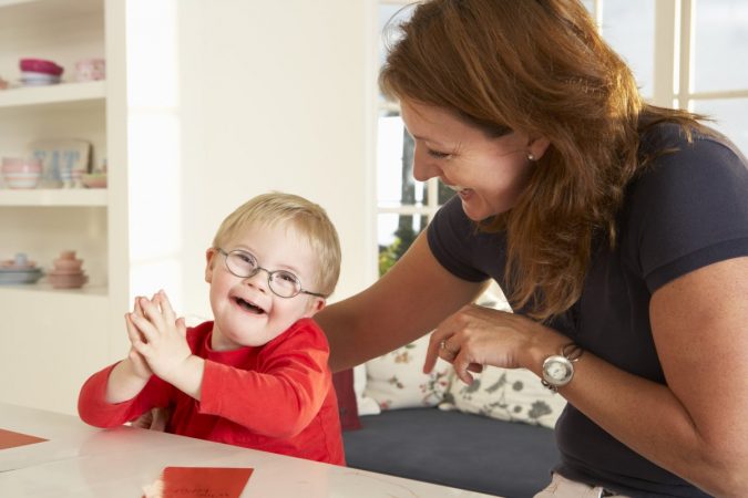 woman and child Downs Syndrome boy having speech therapy Rare Genetic Disorder: 5 Ways to Show a Family Emotional Support - 4