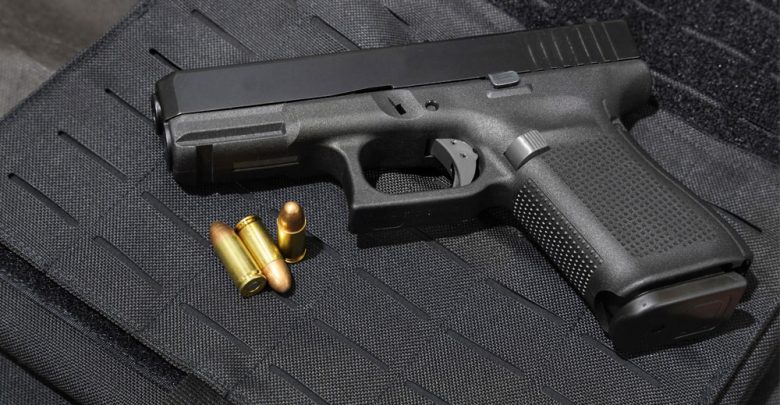 Hand Gun andbullets "Gun Control" vs. "Gun Rights" - Which Decision To Choose? - Gun violence in the USA 1