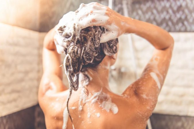 lady-in-a-shower-washing-her-hair-675x450 15 Natural Hair Beauty Tips for All Hair Types