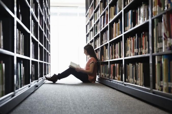 reading in a library 5 Reasons Why You Should Read Classic Novels - 5