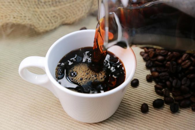 caffeine in coffee poured into cup coffee beans Best Nootropics to Improve Your Brain Power - 3