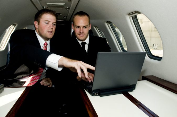 laptop working at private jet 5 Benefits of Renting a Private Jet - 11