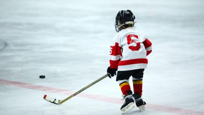 child playing hockey Camp Shohola Explains How to Improve Childhood Fitness - 10
