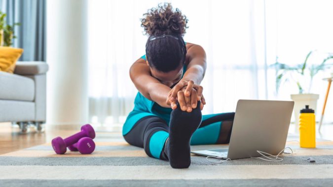 7 Benefits of GetFit Fitness Mobile App for Your Health 8 laptop woman exercising 7 Benefits of GetFit Fitness Mobile App for Your Health - 8