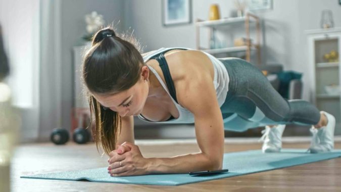 7 Benefits of GetFit Fitness Mobile App for Your Health 9 woman exercising with mobile fittness app 7 Benefits of GetFit Fitness Mobile App for Your Health - 9