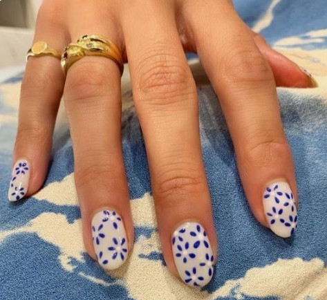 blue flowers against white nails